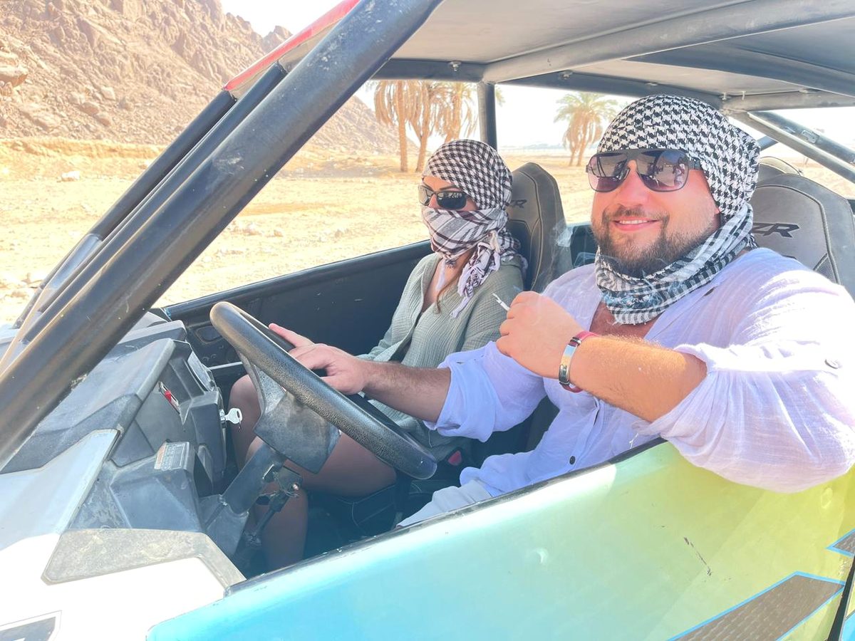 Guests driving a buggy on a private desert route
